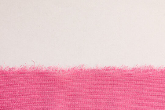 Pink chiffon fabric edge on white background minimal composition with soft textile and raw frayed border