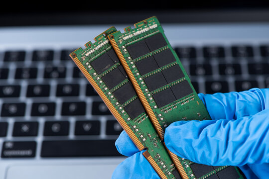 Technician holding ram memory modules for computer upgrade