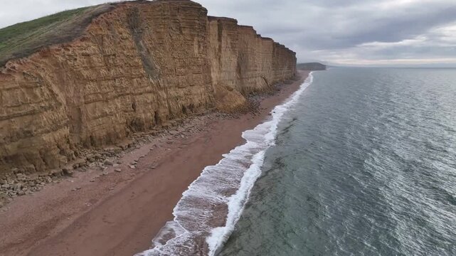 West Bay Dorset East Cliff golden sandstone cliffs aerial drone view Jurassic Coast Broadchurch