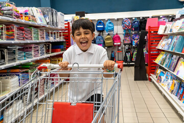 Student with shopping cart buying supplies for back to school © Komuso & Colorsandia