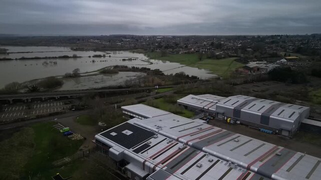 Aerial View Over Industrial Warehouse Rooftops with Flooded River Nene in Irthlingborough