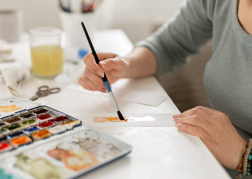 Close-Up Of Woman's Hand Painting Abstract Spot With Watercolor