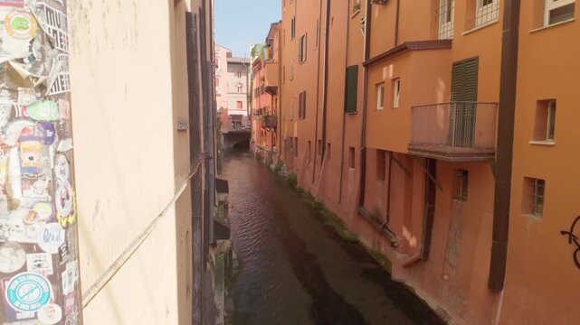 View of Bologna&rsquo;s Canale delle Moline, one of the city&rsquo;s famous waterways near the Via Piella window, showing historic buildings and flowing water in the old town.