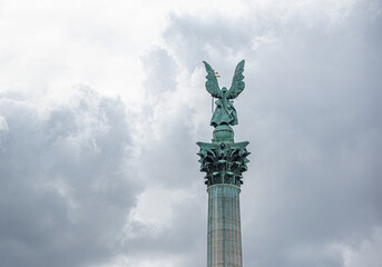 Obraz premium The bronze statue of Archangel Gabriel stands atop the towering Millennium Column in Heroes' Square, Budapest. Rear view.
