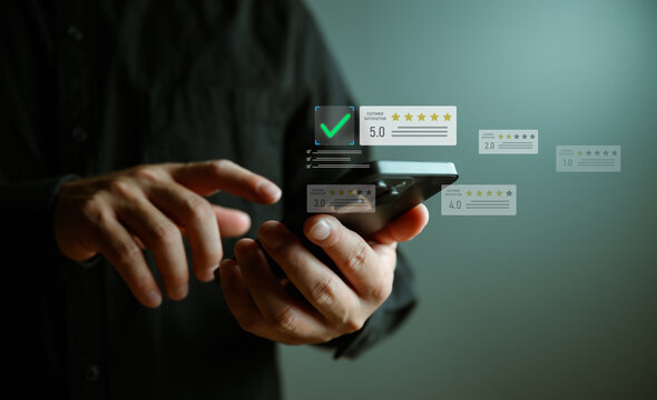Close-up of hands using smartphone with virtual customer satisfaction rating interface, five-star review and quality checklist, representing feedback analysis, user experience, and service quality.