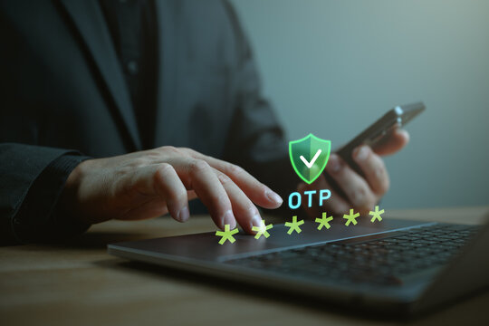 Close-up of a businessman using laptop and smartphone with OTP security icon, representing two-factor authentication, secure login, password protection, cybersecurity, and data privacy.