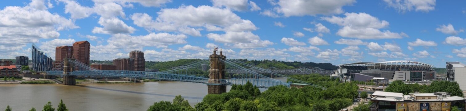 Panorama pano of the Ohio River riverfront including the Roebling Suspension Bridge and Paycor football stadium in Cincinnati.