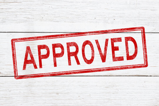 Approved red distressed stamp on weathered wood