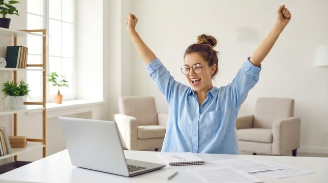 Excited office worker winner using laptop computer celebrating goal achievement. Happy young woman student or employee winning online getting good news in email raising hands feeling euphoric.