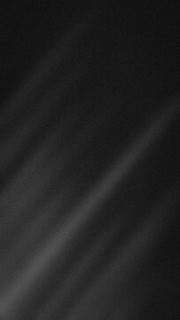 Abstract vertical grainy background featuring deep black dark grey and charcoal tones