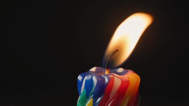 Juneteenth celebration with colorful candle flame symbolizing Freedom Day and Black liberation