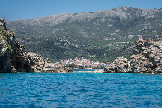 Symmetric View of Budva Old Town Framed by Coastal Rocks - Central Composition