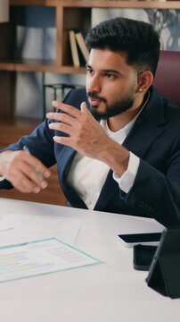 Two business multiracial colleagues discussing documents in office. Businessman and woman having a meeting in office. Two business colleagues discussing over a report document. Slow motion.