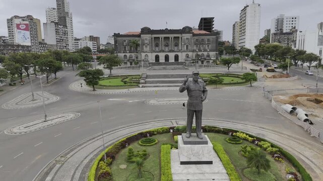Drone slowly approaches statue of Samora Machel at Independence Plaza on an overcast day in Maputo, Mozambique