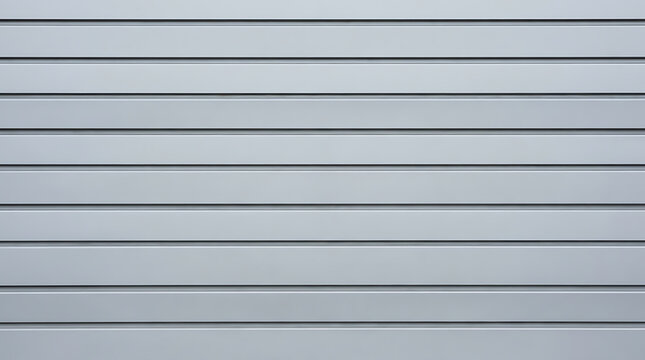 Silver metal roller shutter door with horizontal parallel lines providing a clean industrial texture for background use