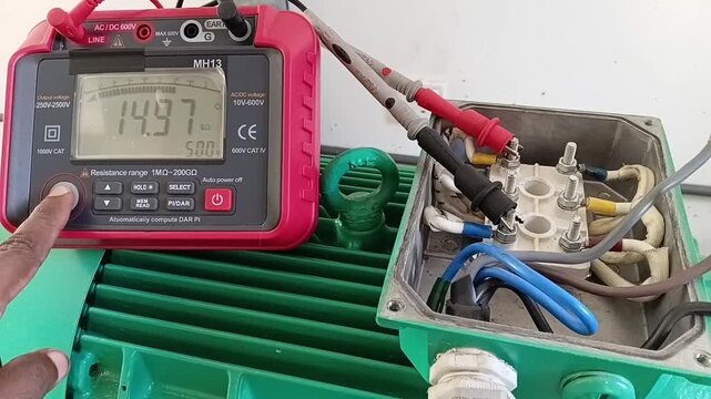 Motor Testing Sequence: Checking Insulation Resistance Between U and W Motor Windings with Digital Tester