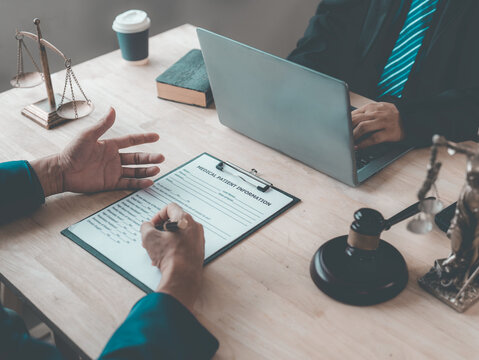 The lawyer advised his client on contractual documents, using a brass scale to explain legal points in court.