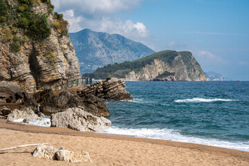 Scenic Mogren Beach with Layered Cliffs and St. Nicholas Island View - Budva © Mariusz