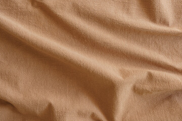 Warm wool fabric texture showing gentle folds, soft nap, subtle tonal shading and tactile surface ideal for sustainable upholstery, cozy garments, product backgrounds and material studies. © Маргарита Трушина