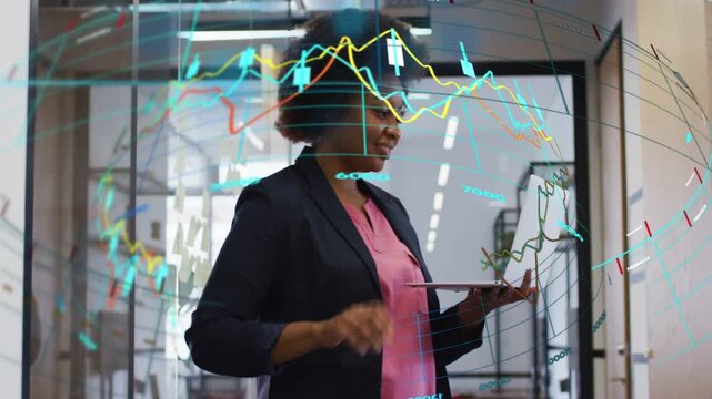 Exec typing on laptop swiping tablet in office analyzing markets with live charts reacting to touch