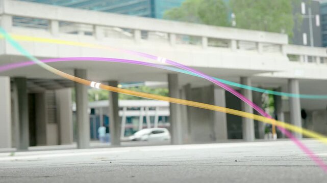 Two men walking plaza toward entrances, low cam tracking feet entering, ribbons sweeping marketing
