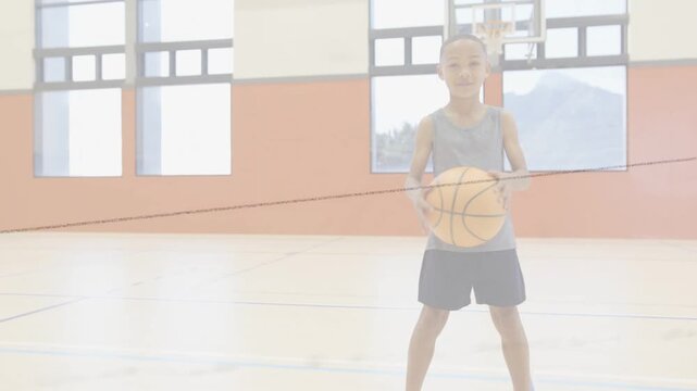 Boy practicing sports on gym court, starting dribble by bouncing ball, animated path tracing motion