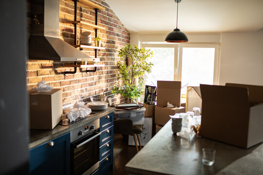 Moving day boxes in modern apartment kitchen