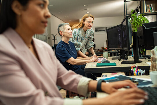 Team of women developers collaborating in modern office