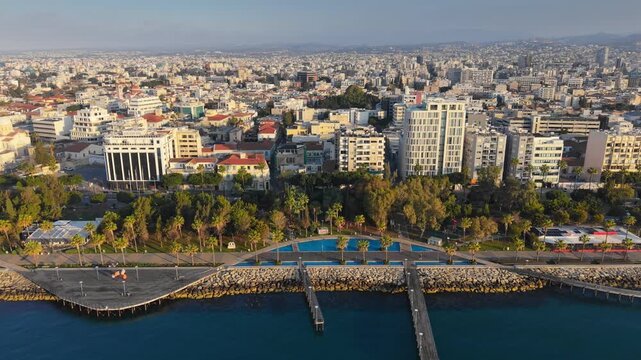 Aerial view of the beautiful Molos promenade in Limassol featuring palm trees and sea docks. Limassol waterfront with its unique wooden piers and palm alley, Cyprus