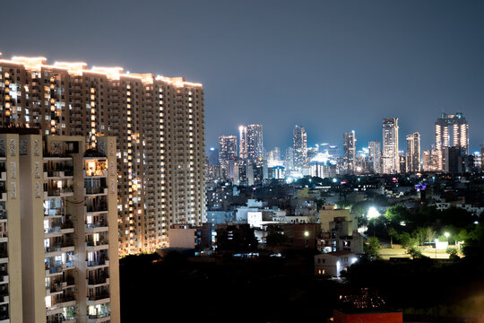 Layers of high rise buildings with small homes, parks and shops in between showing the mix of real estate in cities like gurgaon, noida, chandigarh, bangalore, chennai, pune