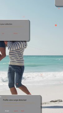Vertical video: Man lifting child walking sand media panels stacking over users viral post sparking
