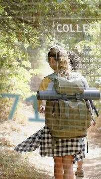 Vertical video: Two hikers walking trail, motion tech overlaying charts and numbers for navigation