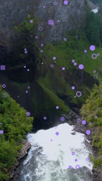 Vertical video: Drone flyin starting cam descent to falls, purple overlays moving to reveal plunge
