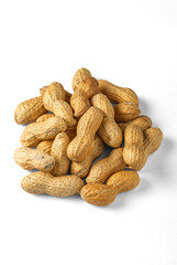 Fototapeta premium Close‑up of a pile of unshelled peanuts on a white background, showing rough texture and natural beige color typical of dried Arachis hypogaea pods used for snacks and food production