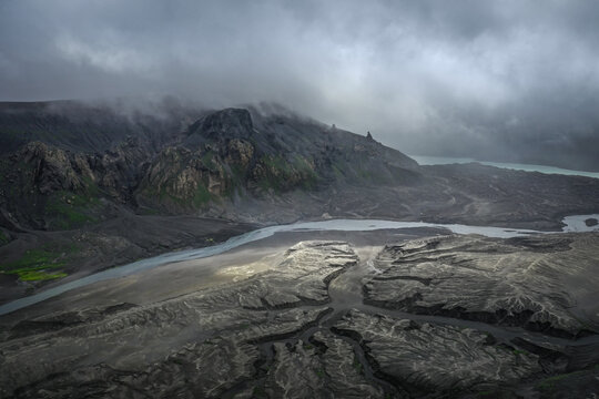 Aerial view of Okmok Volcano caldera with crater lake and glacial snow, Umnak Island, Alaska