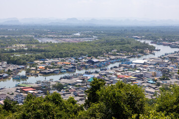 Obraz premium Peaceful scenic aerial view showing coastal town with river winding through beautiful village surrounded by green mountain landscape and calm natural environment