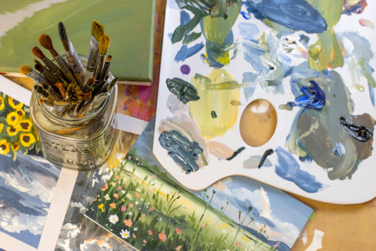 Artist studio setup with brushes and palette, top view flat lay, creative workspace