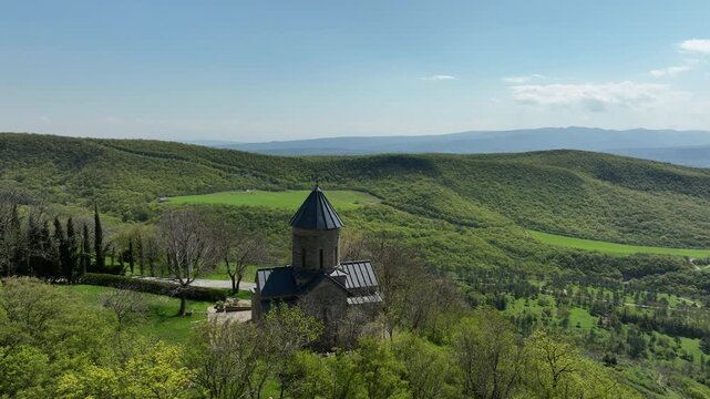 Aerial shot of the Mamkoda Monastery, located near Tbilisi. The image captures the historic stone architecture of the church and its surrounding monastic buildings