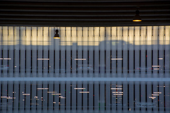 Car park with lights and a car through architectural feature slats (Alicante Airport, Spain)