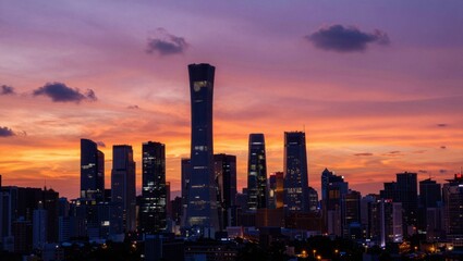 Obraz premium Urban skyline silhouetted at colorful sunset over cityscape
