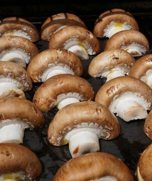 Setas portobello frescas en bandeja con aceite de oliva listas para hornear
