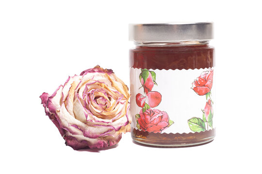 Rose petal jam in a glass jar with a dried rose flower