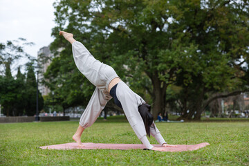 Woman doing yoga in outdoor nature environment