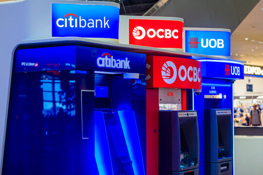 Singapore - 28 December, 2025: Close-up group of ATMs terminals of asian banks: Citibank, OCBC Bank (Oversea-Chinese Banking Corporation) and UOB (United Overseas Bank) at Changi Airport Singapore