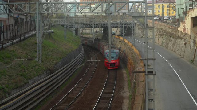 Passenger inter-city train in city near the road