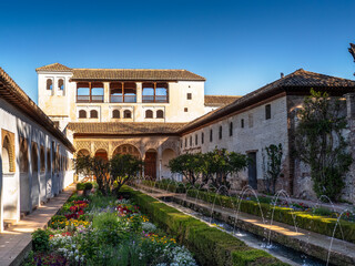 Fototapeta premium Alhambra Courtyard Garden With Ornamental Fountains and Historic Moorish Palace Architecture in Granada