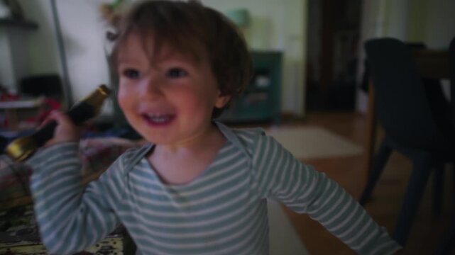 Smiling toddler playing with toy sword at home, imaginative play and joyful childhood moment, creativity and energy in everyday indoor family environment