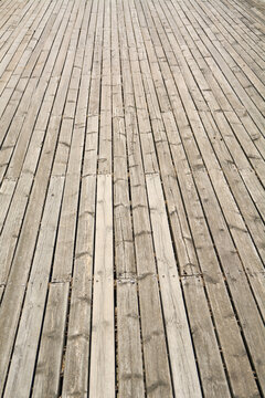 Rustic outdoor timber decking with long parallel lines and textured surface detail ideal for architectural and lifestyle concepts.