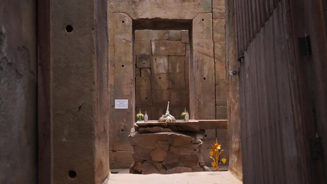 Interior view of an ancient stone altar framed by doorways at Hong Nang Sida Khmer temple ruins, Champasak, Laos.