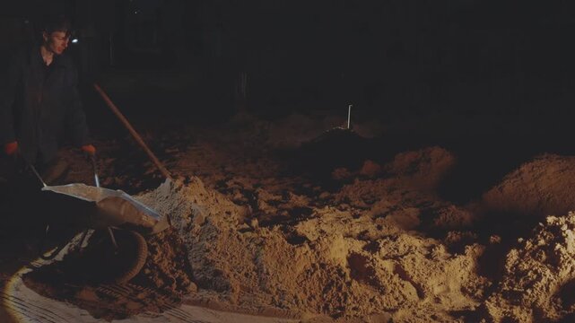 Digging sand, digging sand at night, digging up a pile of sand